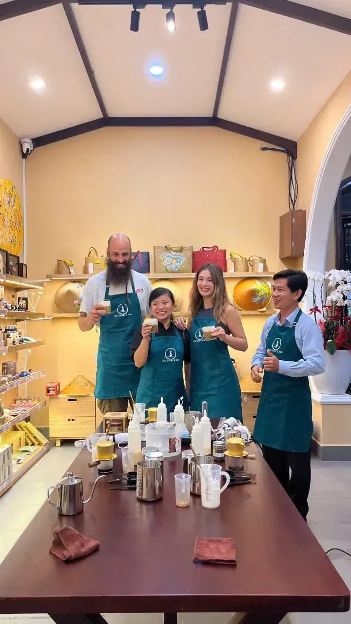 Guests and instructor posing with the coffees they just made
